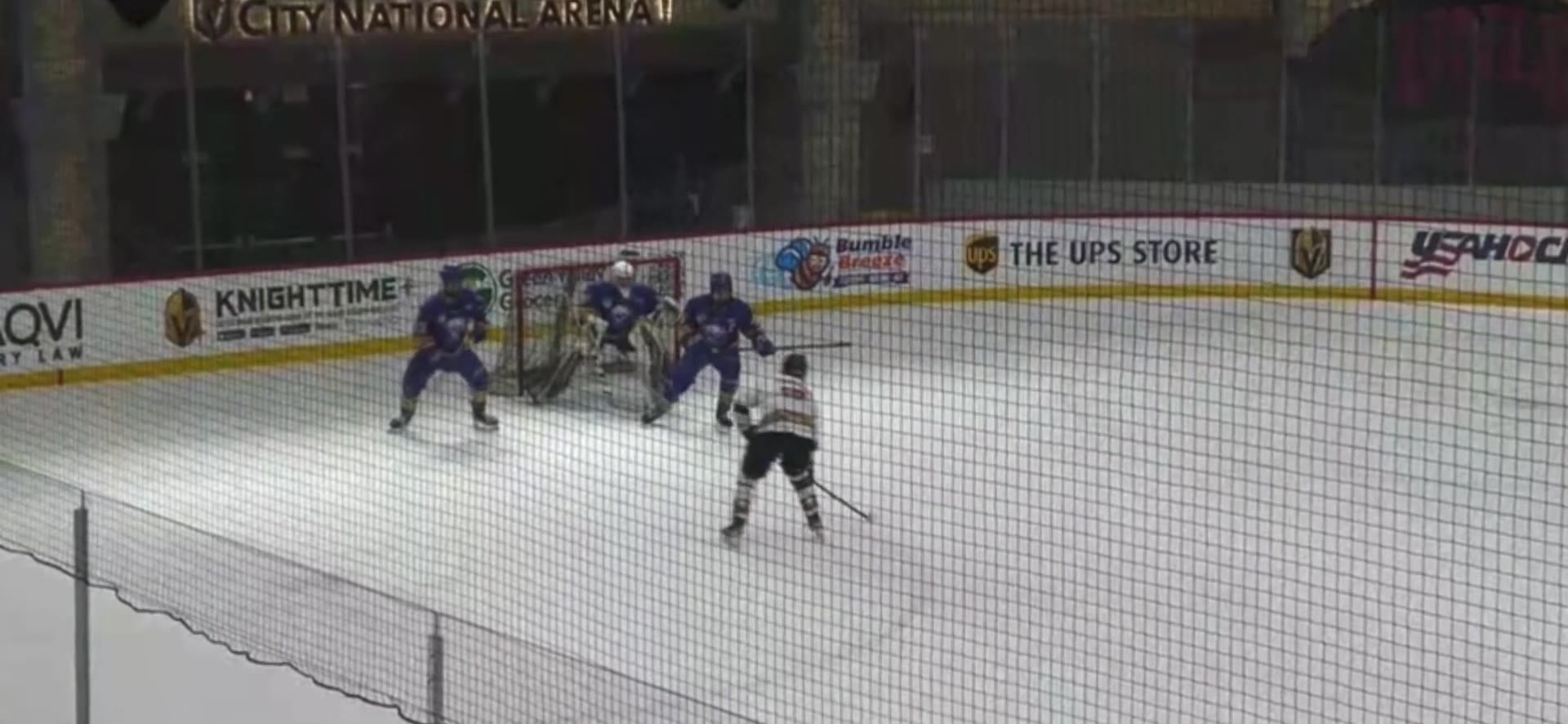 Game film still showing Coach Brayden driving to the net before releasing a shot