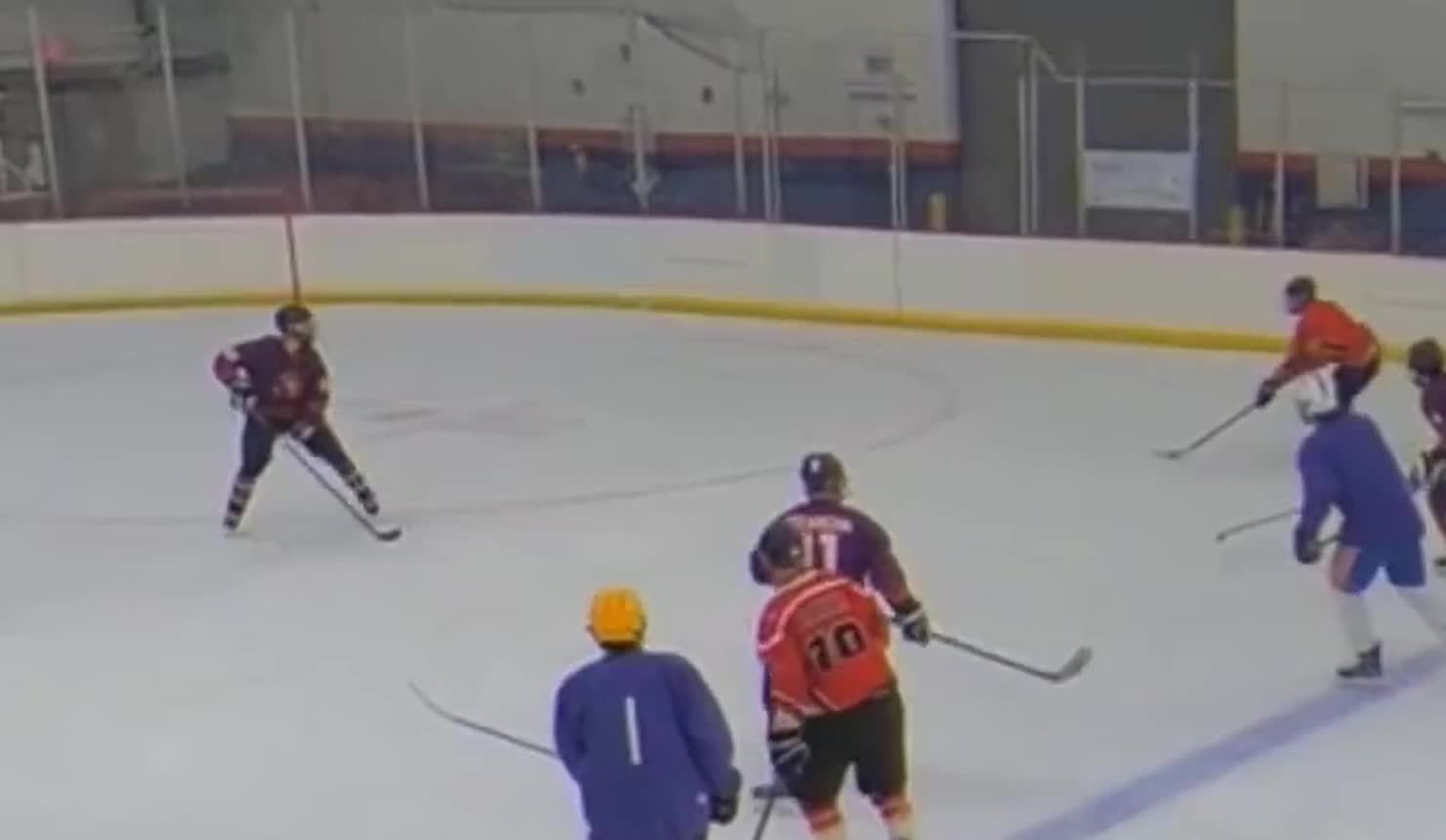 Game film still showing Coach Brayden driving the offensive zone with a defender on his hip