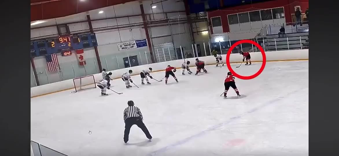 Junior A game film still showing Coach Jack circled as the play develops in the offensive zone