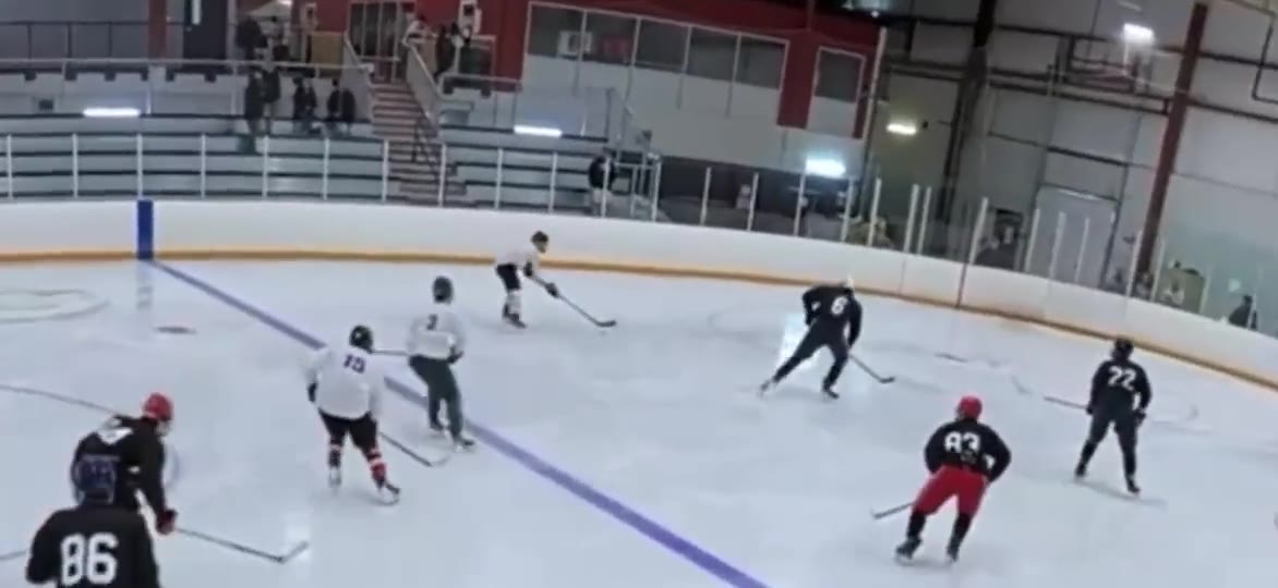 Junior A game film still showing a rush entering the offensive zone toward the net